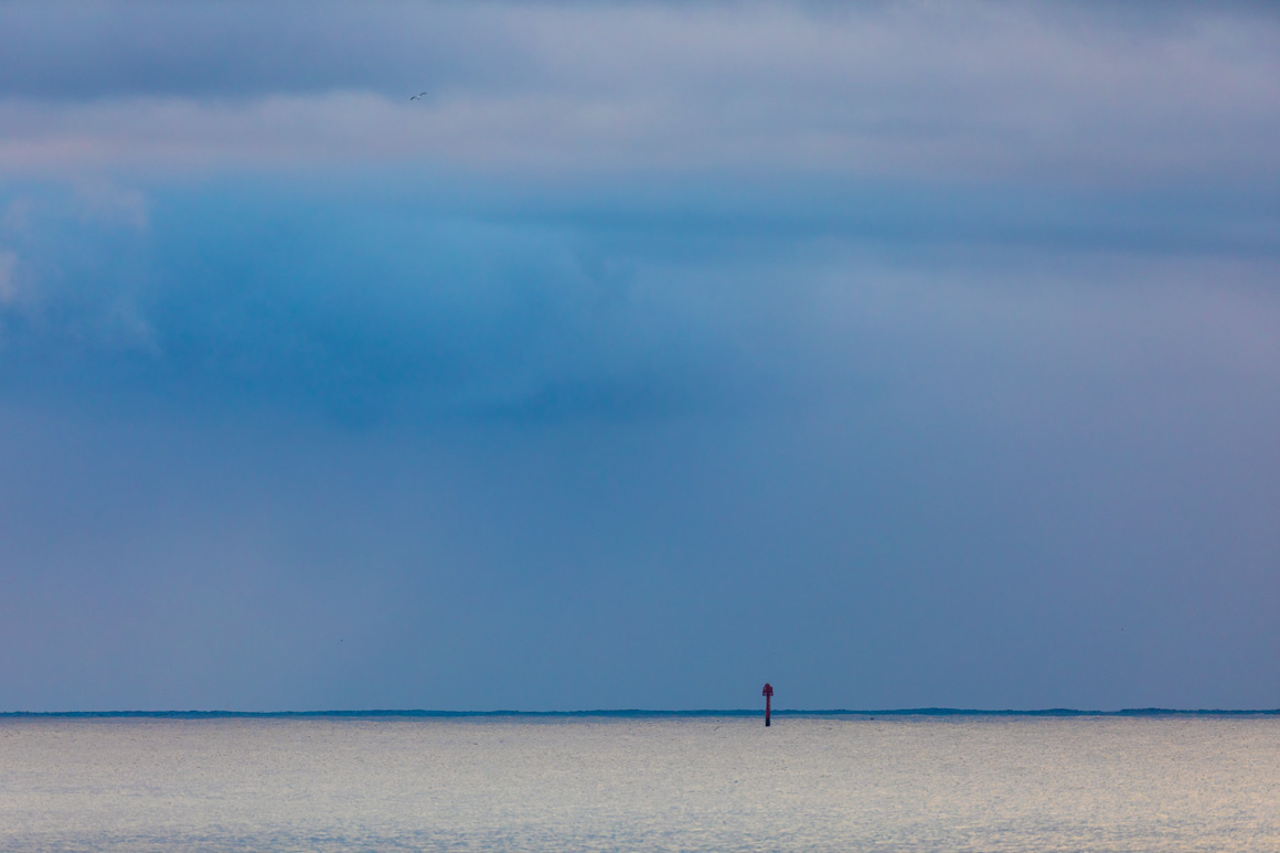 Channel marker, troubled skies