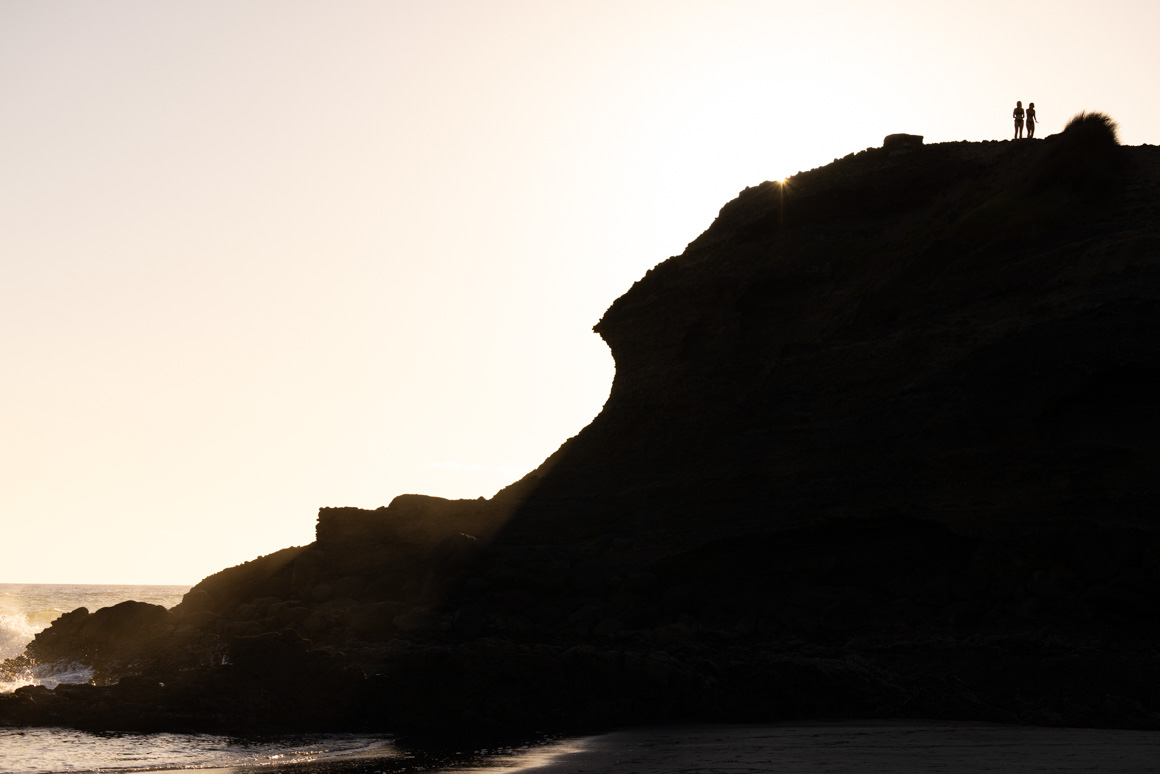 Donna and her friend take in the Piha sunset